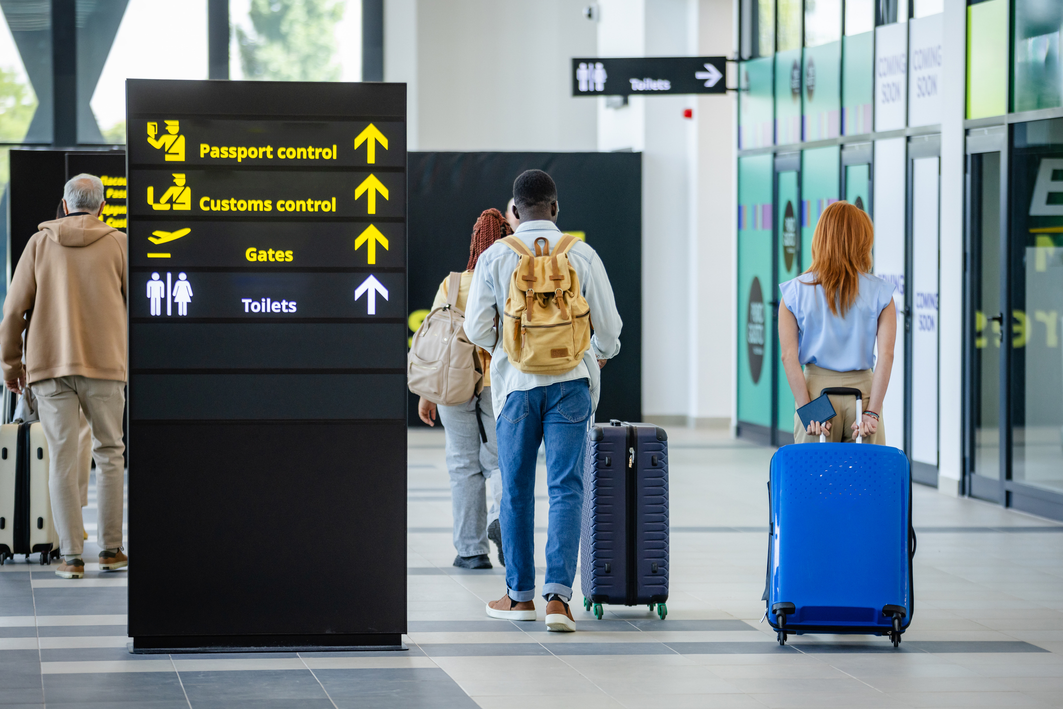People walking towards passport control and customs.